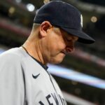 New York Yankees manager Aaron Boone (17) checks his notes before the ninth inning of the MLB interleague game between the Cincinnati Reds and the New York Yankees at Great American Ball Park in downtown Cincinnati on Monday, June 23, 2025.