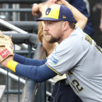 Jul 2, 2025; New York City, New York, USA; Milwaukee Brewers first baseman Rhys Hoskins (12) watches from the dugout prior to game against the New York Mets at Citi Field. Mandatory Credit: Wendell Cruz-Imagn Images