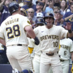 Jul 7, 2025; Milwaukee, Wisconsin, USA; Milwaukee Brewers outfielder Sal Frelick (10) greets first baseman Andrew Vaughn (28) after hitting a home run against the Los Angeles Dodgers in the first inning at American Family Field. Mandatory Credit: Michael McLoone-Imagn Images