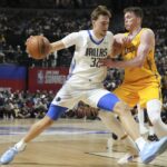 Jul 10, 2025; Las Vegas, NV, USA; Dallas Mavericks forward Cooper Flagg (32) dribbles against Los Angeles Lakers guard Dalton Knecht (4) in the first quarter of their game at Thomas & Mack Center. Mandatory Credit: Candice Ward-Imagn Images