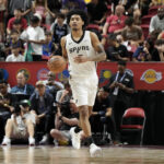 Jul 12, 2025; Las Vegas, NV, USA; San Antonio Spurs guard Dylan Harper (2) dribbles the ball against the Dallas Mavericks in the second quarter of their game at Thomas & Mack Center.