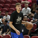 Jul 12, 2025; Las Vegas, NV, USA; Dallas Mavericks forward Cooper Flagg (32) wears Texas Strong warmup t-shirt in support of those impacted by the recent flooding across Texas Hill Country before the Mavericks game against the San Antonio Spurs at Thomas & Mack Center.