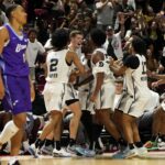 Jul 14, 2025; Las Vegas, NV, USA; San Antonio Spurs forward Riley Minix (27) celebrates with teammates after scoring against the Utah Jazz during overtime in a NBA basketball game at the Thomas & Mack Center. Mandatory Credit: Lucas Peltier-Imagn Images