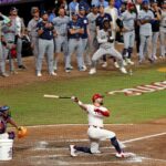Jul 15, 2025; Cumberland, Georgia, USA; National League designated hitter Kyle Schwarber (12) of the Philadelphia Phillies hits a home run in the swing off of after the 2025 MLB All Star Game ended in a tie at Truist Park.