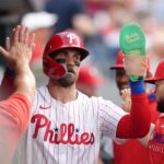Jul 22, 2025; Philadelphia, Pennsylvania, USA; Philadelphia Phillies infielder Bryce Harper (3) celebrates with teammates after scoring a run against the Boston Red Sox in the first inning at Citizens Bank Park.