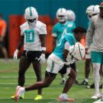 Jul 23, 2025; Miami Gardens, FL, USA; Miami Dolphins cornerback Artie Burns (23) reacts during training camp as wide receiver Tyreek Hill (10) watches at Baptist Health Training Complex. Mandatory Credit: Sam Navarro-Imagn Images