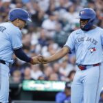 Jul 25, 2025; Detroit, Michigan, USA; Toronto Blue Jays outfielder George Springer (4) and first baseman Vladimir Guerrero Jr. (27) congratulate each other after scoring in the fifth inning against the Detroit Tigers at Comerica Park.