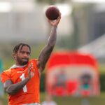 Jul 28, 2025; Miami Gardens, MI, USA; Miami Dolphins quarterback Tua Tagovailoa (1) throws a football during training camp at Baptist Health Training Complex. Mandatory Credit: Sam Navarro-Imagn Images