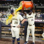 Jul 29, 2025; Milwaukee, Wisconsin, USA; Milwaukee Brewers shortstop Andruw Monasterio (14) dumps Gatorade over Milwaukee Brewers first base Andrew Vaughn (28) head after the game in which Milwaukee Andrew Vaughn (28) hit a grand slam against the Chicago Cubs at American Family Field. Mandatory Credit: Michael McLoone-Imagn Images