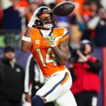Dec 15, 2024; Denver, Colorado, USA; Denver Broncos wide receiver Courtland Sutton (14) prepares to pull in a touchdown reception in the fourth quarter against the Indianapolis Colts at Empower Field at Mile High.