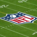 Feb 1, 2025; Orlando, FL, USA; An overall view of the NFL shield logo at midfield on the Camping World Stadium flag football field.