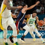 PARIS, FRANCE - AUGUST 06: Raul Neto of Brazil (R) in action with Stephen Curry of the United States during the Men's Basketball Quarterfinal match between Brazil and United States of America on day eleven of the Olympic Games Paris 2024 at Bercy Arena on August 06, 2024 in Paris, France.