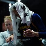 Aug 17, 2025; Uncasville, Connecticut, USA; Indiana Fever guard Sophie Cunningham (8) is helped off the court injured as they take on the Connecticut Sun in the first half at Mohegan Sun Arena.