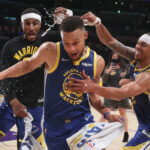 Oct 19, 2021; Los Angeles, California, USA; Golden State Warriors guard Stephen Curry (30) escapes from guard Gary Payton II (0) and guard Damion Lee (1) after the Warriors defeated the Los Angeles Lakers 121-114 at Staples Center.