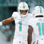 Miami Dolphins quarterback Tua Tagovailoa (1) and wide receiver Tyreek Hill (10) take the field before the opening game of the season against the New England Patriots at Hard Rock Stadium in Miami Gardens, Sept. 11, 2022.
