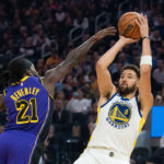 October 18, 2022; San Francisco, California, USA; Golden State Warriors guard Klay Thompson (11) shoots the basketball against Los Angeles Lakers guard Patrick Beverley (21) during the first quarter at Chase Center.