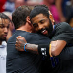Feb 22, 2024; Dallas, Texas, USA; Dallas Mavericks guard Kyrie Irving (11) celebrates with Mark Cuban during the second half against the Phoenix Suns at American Airlines Center.