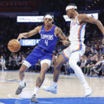 Feb 22, 2024; Oklahoma City, Oklahoma, USA; Oklahoma City Thunder guard Shai Gilgeous-Alexander (2) defends a drive by LA Clippers guard Brandon Boston Jr. (4) during the second half at Paycom Center.