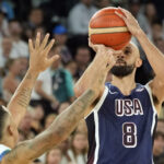 Aug 6, 2024; Paris, France; United States guard Derrick White (8) shoots against Brazil point guard Yago Santos (2) in the first half in a men’s basketball quarterfinal game during the Paris 2024 Olympic Summer Games at Accor Arena. Mandatory Credit: Kyle Terada-USA TODAY Sports