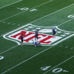 Sep 5, 2024; Sao Paolo, Brazil; Workers paint the NFL shield logo at midfield before the 2024 NFL Sao Paolo game between the Philadelphia Eagles and the Green Bay Packers at Neo Quimica Arena. Mandatory Credit: Kirby Lee-Imagn Images