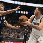 Nov 3, 2024; Dallas, Texas, USA; Dallas Mavericks guard Luka Doncic (77) shoots over Orlando Magic forward Franz Wagner (22) during the second quarter at the American Airlines Center.