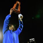 Miami Northwestern's Teddy Bridgewater raises the state trophy following the team's win over Raines in the Class 3A championship on Dec. 14, 2024.