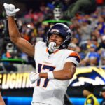 Dec 19, 2024; Inglewood, California, USA; Denver Broncos wide receiver Devaughn Vele (17) celebrates his touchdown scored against the Los Angeles Chargers with tight end Nate Adkins (45) during the first half at SoFi Stadium.