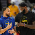 Dec 25, 2024; San Francisco, California, USA; Golden State Warriors guard Stephen Curry (left) and Los Angeles Lakers forward LeBron James (right) talk before the game at Chase Center. Mandatory Credit: Darren Yamashita-Imagn Images
