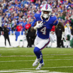 Dec 29, 2024; Orchard Park, New York, USA; Buffalo Bills running back James Cook (4) runs with the ball against the New York Jets during the second half at Highmark Stadium. Mandatory Credit: Gregory Fisher-Imagn Images