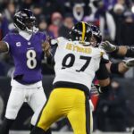 NFL Grupo Globo Jan 11, 2025; Baltimore, Maryland, USA; Baltimore Ravens quarterback Lamar Jackson (8) passes the ball as Pittsburgh Steelers defensive tackle Cameron Heyward (97) defends in an AFC wild card game at M&T Bank Stadium.