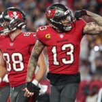 Jan 12, 2025; Tampa, Florida, USA; Tampa Bay Buccaneers wide receiver Mike Evans (13) celebrates after a touchdown catch with tight end Cade Otton (88) during the second quarter of a NFC wild card playoff against the Washington Commanders at Raymond James Stadium. Mandatory Credit: Kim Klement Neitzel-Imagn Images