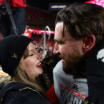 Jan 26, 2025; Kansas City, MO, USA; Recording artist Taylor Swift and Kansas City Chiefs tight end Travis Kelce (87) react after the AFC Championship game against the Buffalo Bills at GEHA Field at Arrowhead Stadium. Mandatory Credit: Mark J. Rebilas-Imagn Images