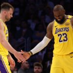 Feb 27, 2025; Los Angeles, California, USA; Los Angeles Lakers guard Luka Doncic (77) and forward LeBron James (23) celebrate after a play during the fourth quarter against the Minnesota Timberwolves at Crypto.com Arena. Mandatory Credit: Jason Parkhurst-Imagn Images