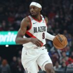 Mar 9, 2025; Portland, Oregon, USA; Portland Trail Blazers forward Jerami Grant (9) brings the ball up the court against Detroit Pistons center Jalen Duren (0) in the first half at Moda Center. Mandatory Credit: Jaime Valdez-Imagn Images
