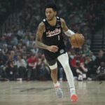 Mar 23, 2025; Portland, Oregon, USA; Portland Trail Blazers guard Anfernee Simons (1) dribbles the ball during the first half against the Boston Celtics at Moda Center.