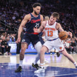 Mar 26, 2025; New York, New York, USA; New York Knicks guard Tyler Kolek (13) looks to drive past LA Clippers guard Ben Simmons (25) in the third quarter at Madison Square Garden.