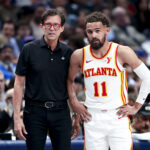 Apr 2, 2025; Dallas, Texas, USA; Atlanta Hawks head coach Quin Snyder speaks with Atlanta Hawks guard Trae Young (11) during the first half against the Dallas Mavericks at American Airlines Center.