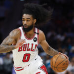Apr 6, 2025; Charlotte, North Carolina, USA; Chicago Bulls guard Coby White (0) drives to the basket against the Charlotte Hornets during the second half at Spectrum Center.
