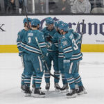Apr 7, 2025; San Jose, California, USA; San Jose Sharks celebrate after scoring a goal during the first period against the Calgary Flames at SAP Center at San Jose. Mandatory Credit: Stan Szeto-Imagn Images