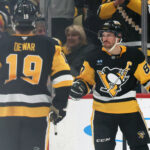 Apr 17, 2025; Pittsburgh, Pennsylvania, USA; Pittsburgh Penguins center Sidney Crosby (87) reacts with center Connor Dewar (19) after Crosby scored a goal against the Washington Capitals during the second period at PPG Paints Arena. Mandatory Credit: Charles LeClaire-Imagn Images