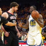 Apr 26, 2025; San Francisco, California, USA; Houston Rockets center Alperen Sengun (center left) and Golden State Warriors forward Draymond Green (23) argue as referee Curtis Blair (74) intervenes during the fourth quarter of game three of first round for the 2024 NBA Playoffs at Chase Center.