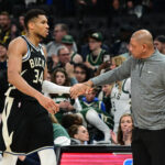 Apr 27, 2025; Milwaukee, Wisconsin, USA; Milwaukee Bucks forward Giannis Antetokounmpo (34) exits the game in the fourth quarter as head coach Doc Rivers shakes his hand during game four against the Indiana Pacers of first round for the 2024 NBA Playoffs at Fiserv Forum.