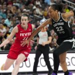 Jun 22, 2025; Las Vegas, Nevada, USA; Indiana Fever guard Caitlin Clark (22) dribbles the ball against Las Vegas Aces center A'ja Wilson (22) during the second half of a WNBA basketball game at T-Mobile Arena.