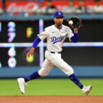 Jul 21, 2025; Los Angeles, California, USA; Los Angeles Dodgers shortstop Mookie Betts (50) fields the ground ball of Minnesota Twins third baseman Royce Lewis (23) during the sixth inning at Dodger Stadium. Mandatory Credit: Gary A. Vasquez-Imagn Images