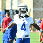 Jul 23, 2025; Rochester, NY, USA; Buffalo Bills running back James Cook (4) warms up during training camp at St. John Fisher University. Mandatory Credit: Mark Konezny-Imagn Images