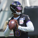 Jul 23, 2025; Owings Mills, MD, USA; Baltimore Ravens quarterback Lamar Jackson (8) warms up during training camp at Under Armour Performance Center. Mandatory Credit: Mitch Stringer-Imagn Images