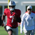 Jul 24, 2025; Henderson, NV, USA; Las Vegas Raiders quarterback Geno Smith (7) with coach Pete Carroll during training camp at the Intermountain Healthcare Performance Center. Mandatory Credit: Kirby Lee-Imagn Images