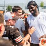Jul 26, 2025; Berea, OH, USA; Cleveland Browns quarterback Shedeur Sanders (12) talks to a fan during training camp at CrossCountry Mortgage Campus.