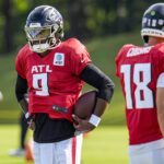 Jul 29, 2025; Atlanta, GA, USA; Atlanta Falcons quarterback Michael Penix Jr. (9) shown next to quarterback Kirk Cousins (18) during practice at training camp at IBM Performance Field. Mandatory Credit: Dale Zanine-Imagn Images