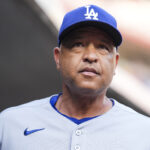 Jul 29, 2025; Cincinnati, Ohio, USA; Los Angeles Dodgers manager Dave Roberts (30) stands in the dugout before the game against the Cincinnati Reds at Great American Ball Park. Mandatory Credit: Aaron Doster-Imagn Images